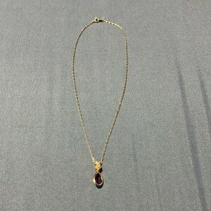 Beautiful trifari gold tone necklace with a purple crystal. 18”